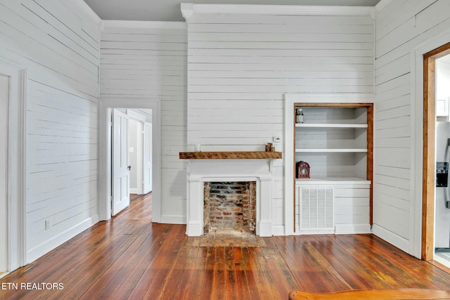 unfurnished living room featuring crown molding, a fireplace, and dark hardwood / wood-style floors