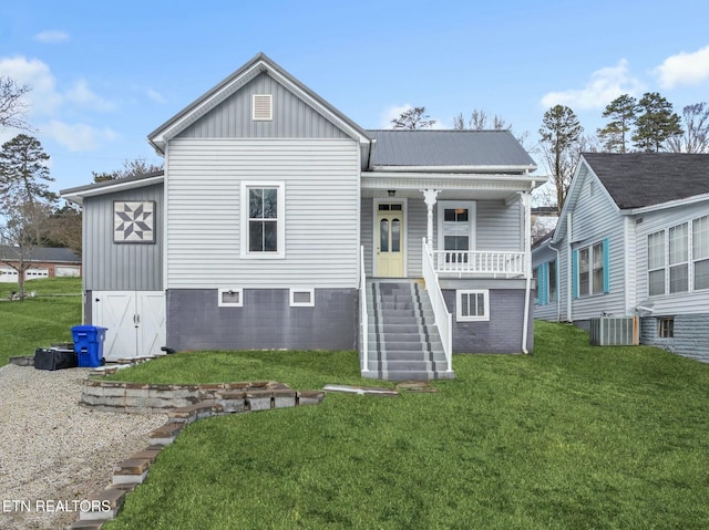 rear view of property with a porch, central AC, and a lawn