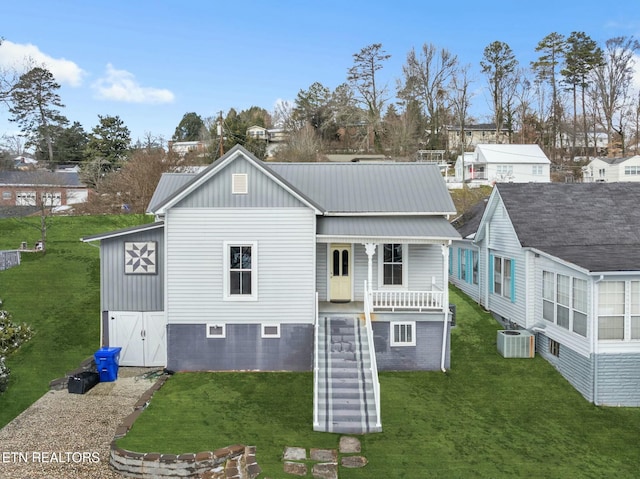 rear view of house with central AC unit and a yard