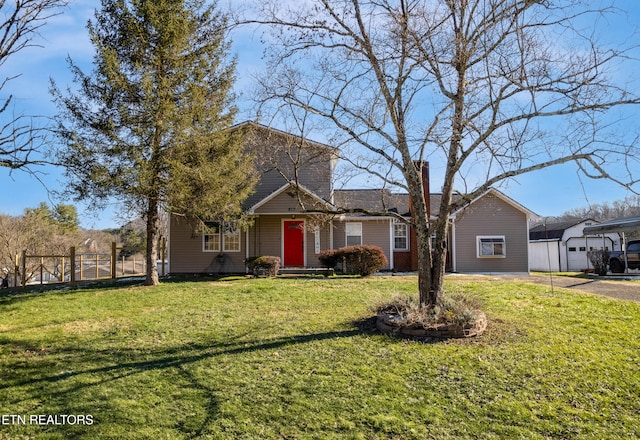 view of front of house with an outbuilding, a front lawn, and a garage