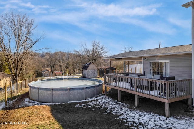 snow covered pool featuring a deck