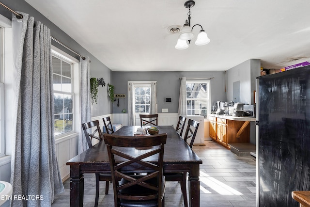 dining room featuring a notable chandelier and a healthy amount of sunlight