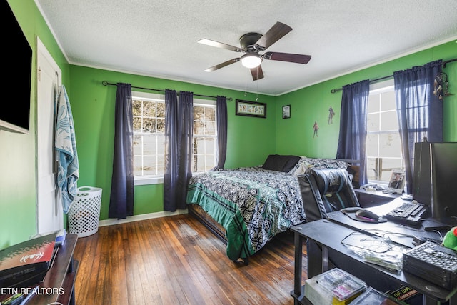 bedroom with ceiling fan, dark hardwood / wood-style floors, and a textured ceiling