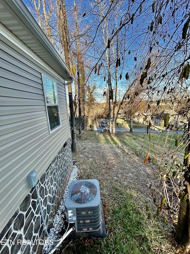 view of yard featuring central air condition unit