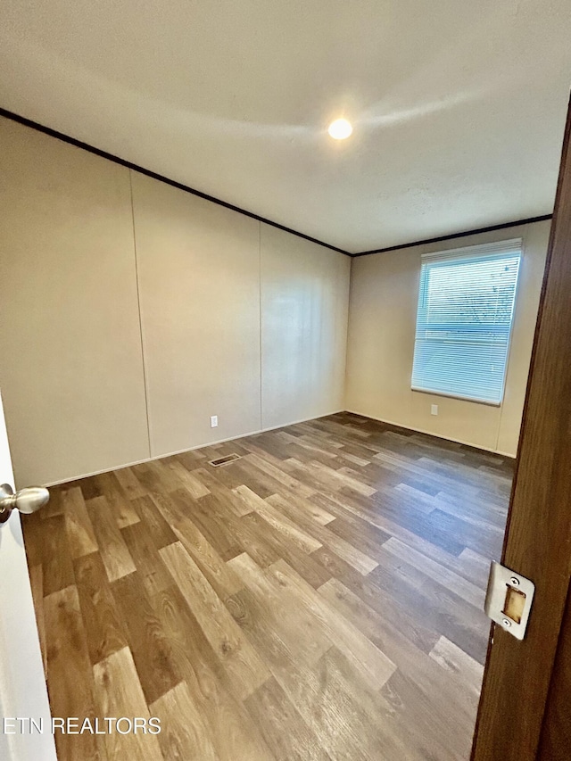 spare room featuring hardwood / wood-style flooring