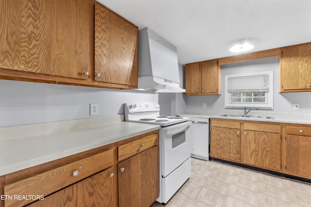 kitchen with sink, white appliances, and wall chimney exhaust hood