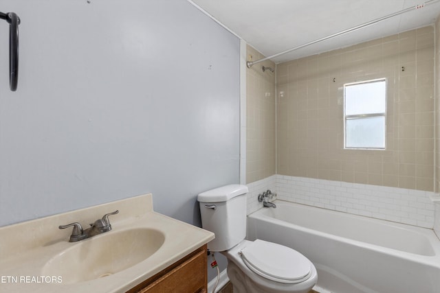 full bathroom with vanity, tiled shower / bath combo, and toilet