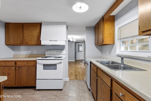 kitchen with electric range, dishwasher, light hardwood / wood-style floors, sink, and an inviting chandelier