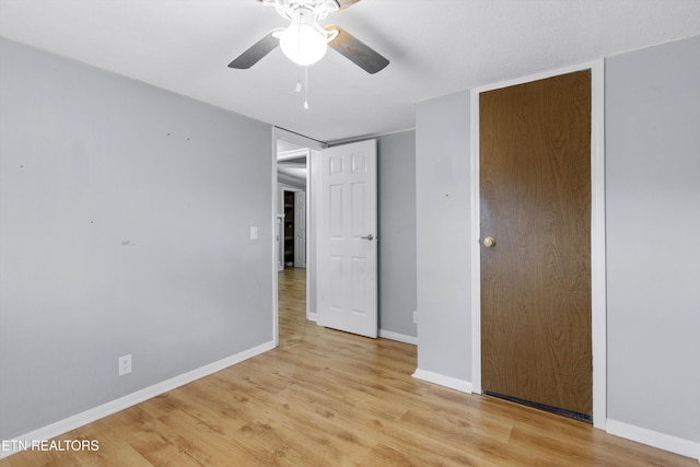 unfurnished bedroom with ceiling fan and light hardwood / wood-style flooring