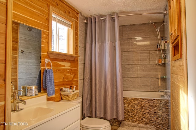 full bathroom with toilet, wood walls, shower / bath combo with shower curtain, a textured ceiling, and vanity