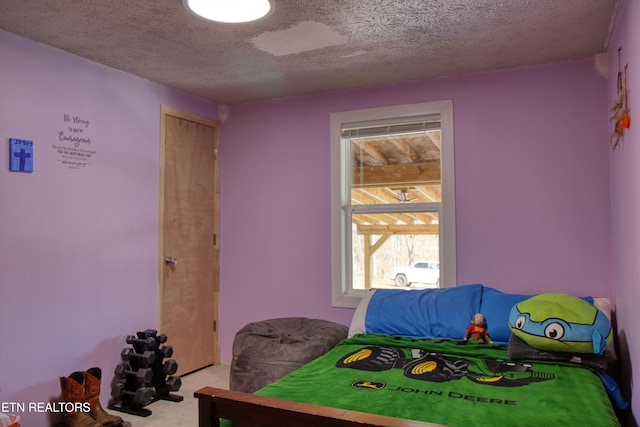 carpeted bedroom with a textured ceiling