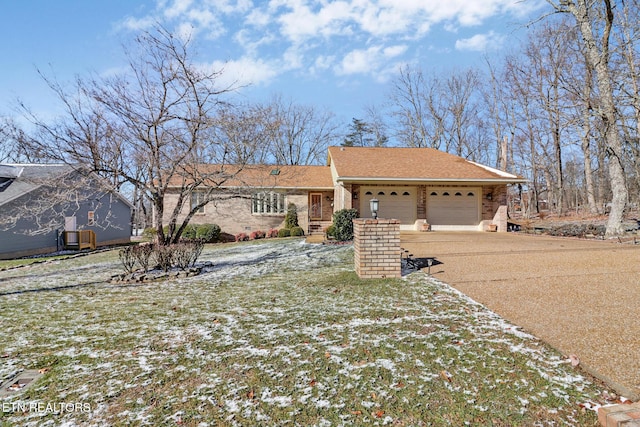 ranch-style home featuring a garage and a front yard