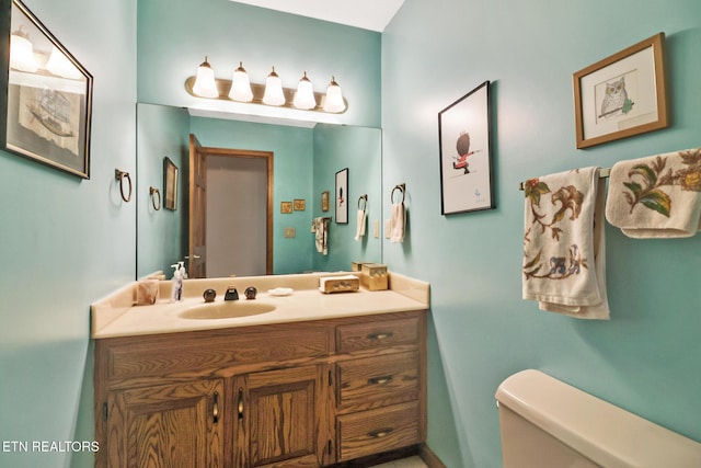 bathroom featuring vanity and toilet