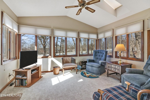 sunroom with ceiling fan and vaulted ceiling with skylight