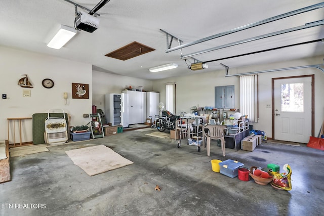 garage featuring a garage door opener and electric panel