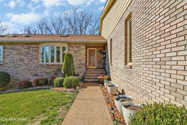 144 Greenwood Rd, Crossville, TN 38558 - doorway to property featuring a yard, brick siding, and a shingled roof