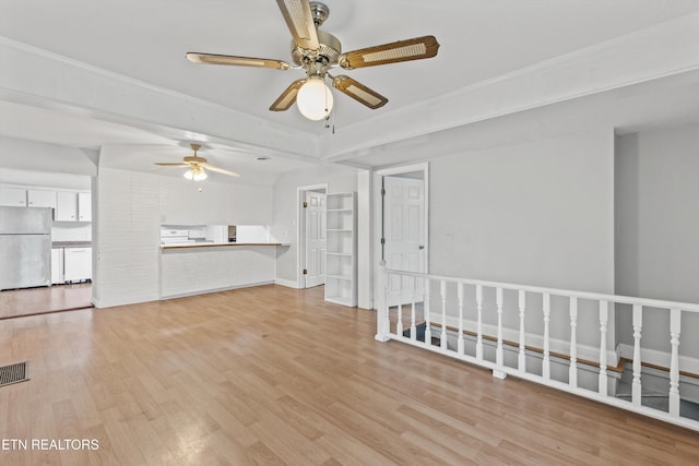 unfurnished living room featuring lofted ceiling, ceiling fan, and light hardwood / wood-style floors