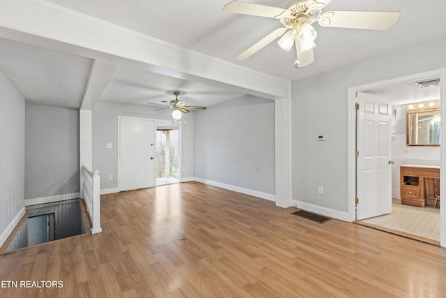 unfurnished living room featuring ceiling fan and light hardwood / wood-style flooring