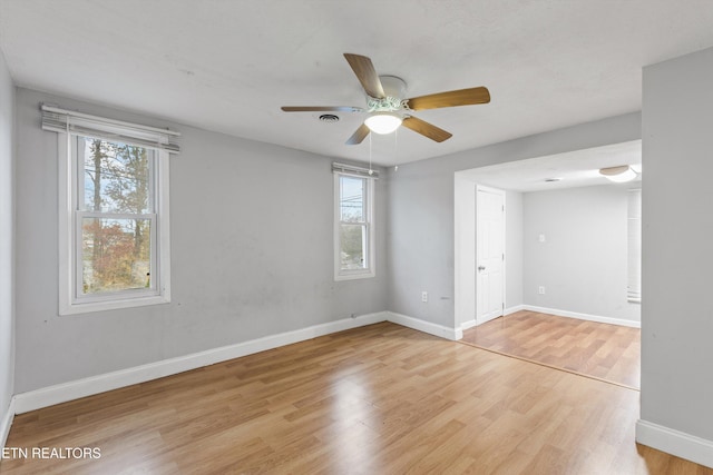 spare room with light wood-type flooring and ceiling fan