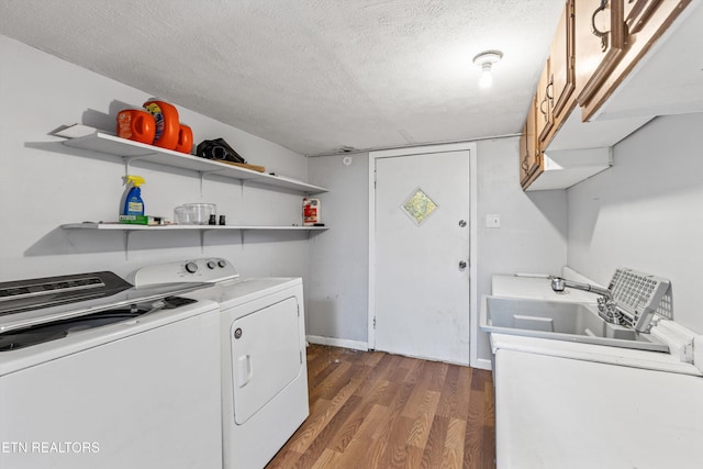 laundry area featuring independent washer and dryer, a textured ceiling, dark hardwood / wood-style floors, cabinets, and sink