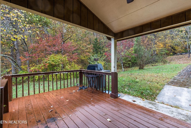 wooden terrace featuring a yard