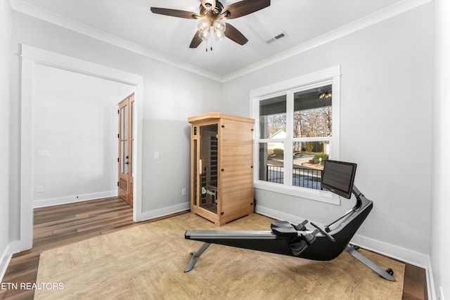 workout area with ceiling fan, crown molding, and wood-type flooring