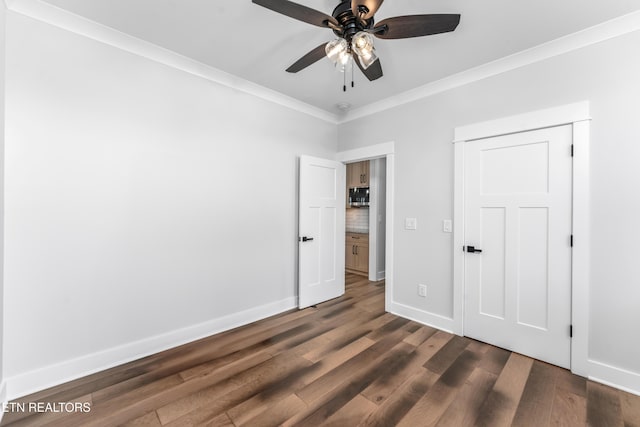 unfurnished bedroom featuring ceiling fan, ornamental molding, a closet, and dark hardwood / wood-style flooring