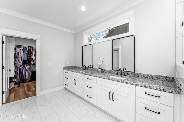 bathroom featuring vanity and ornamental molding