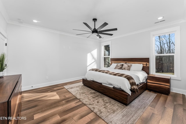 bedroom with ceiling fan, ornamental molding, and hardwood / wood-style flooring