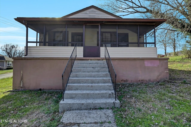 view of front of property with a sunroom