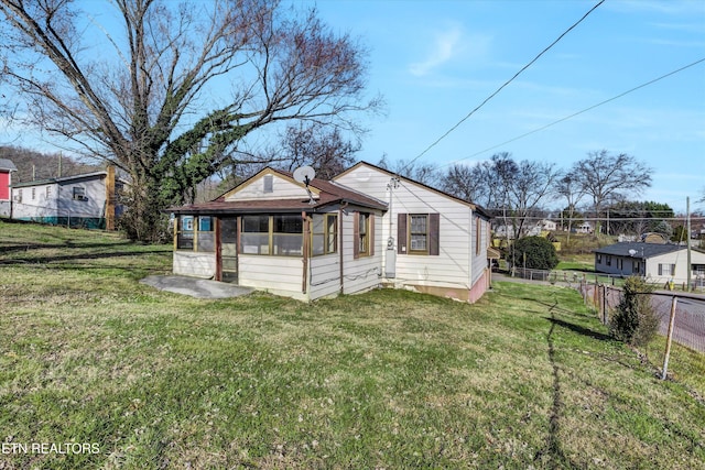 view of front of home featuring a front lawn and a sunroom