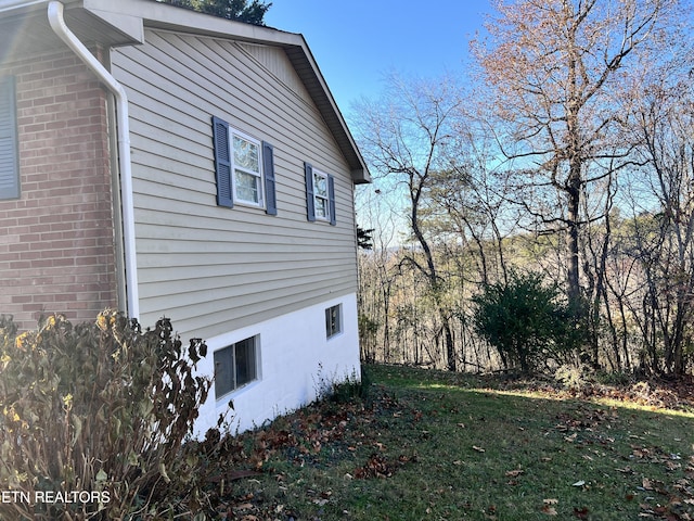 view of side of home featuring a yard