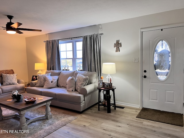 living room featuring ceiling fan, light hardwood / wood-style floors, and plenty of natural light