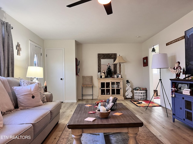 living room featuring ceiling fan and light hardwood / wood-style flooring