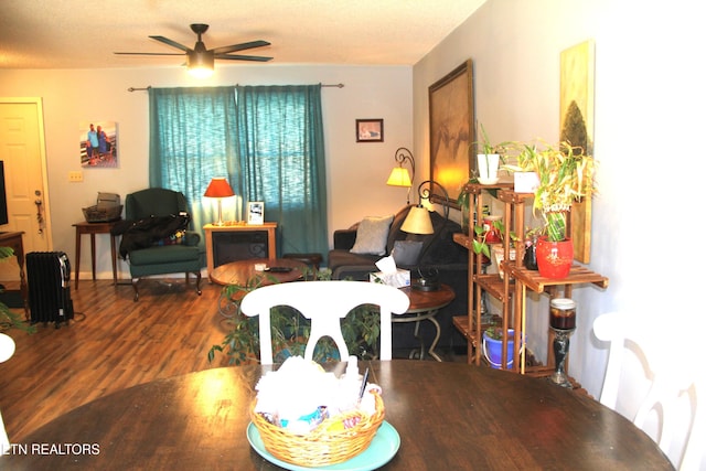 living room with hardwood / wood-style flooring and ceiling fan