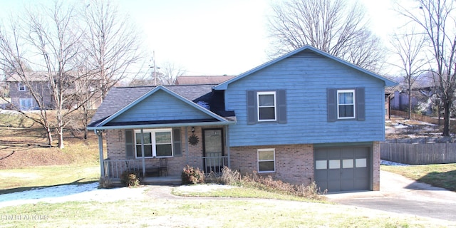 view of front facade with covered porch, a front lawn, and a garage