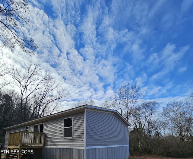 view of home's exterior featuring a wooden deck