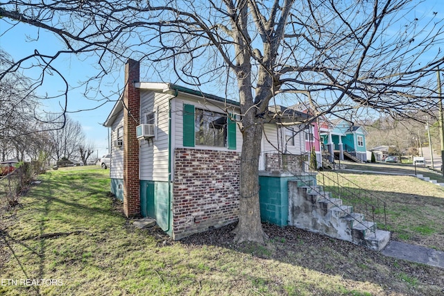 view of property exterior with cooling unit and a yard