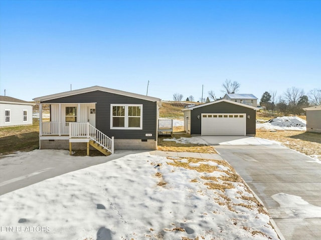 view of front of property with a garage and an outbuilding