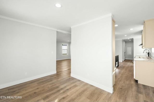 169 Dode St, Sweetwater, TN 37874 - empty room with a sink, recessed lighting, ornamental molding, wood finished floors, and baseboards