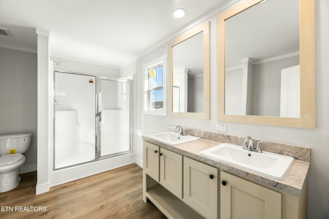 169 Dode St, Sweetwater, TN 37874 - bathroom with a stall shower, toilet, double vanity, wood finished floors, and ornamental molding
