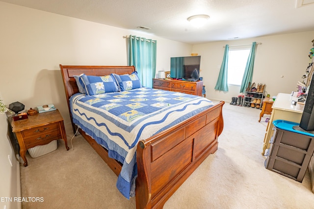 bedroom featuring light carpet