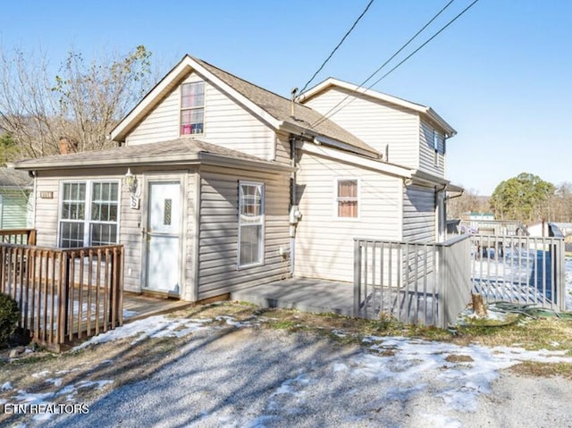 back of property featuring a wooden deck