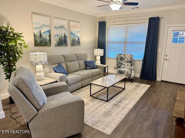 living room featuring crown molding, plenty of natural light, dark hardwood / wood-style floors, and ceiling fan