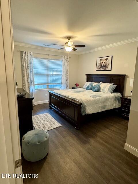 bedroom featuring crown molding, ceiling fan, and dark hardwood / wood-style flooring