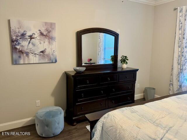 bedroom featuring wood-type flooring and ornamental molding