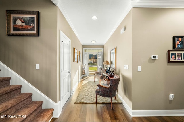 corridor featuring hardwood / wood-style floors and ornamental molding