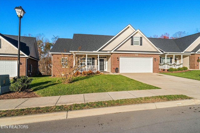 view of front facade featuring a garage, a front yard, and a porch