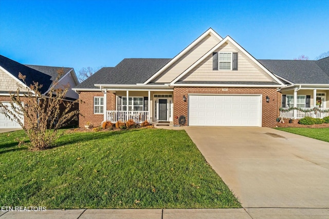 view of front of home with covered porch, a garage, and a front lawn