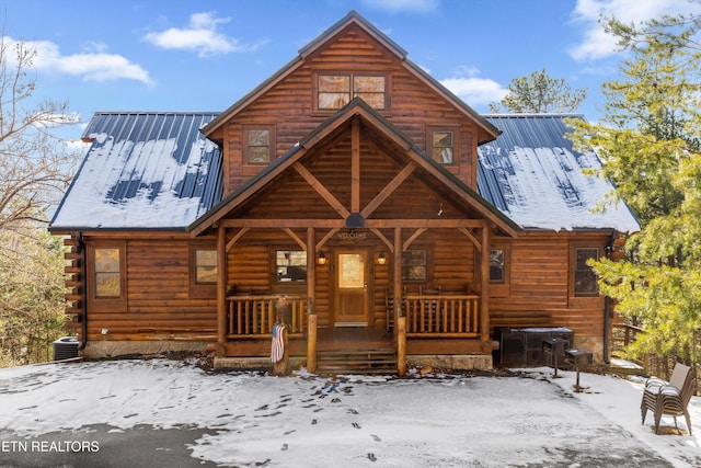 log home featuring central AC unit and a porch